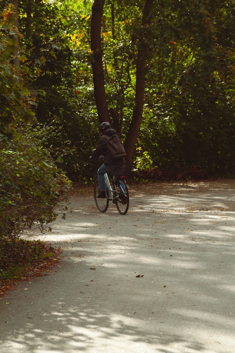 A person riding a bike on a path in the woods